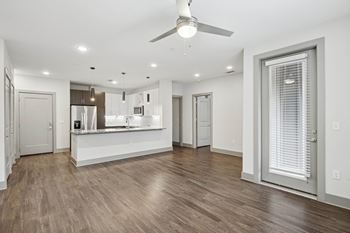 Skye suwanee town center apartments in suwanee, georgia living room and kitchen with high ceilings